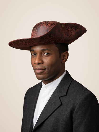 Brass Riveted Tricorn Pirate Hat in Brown, worn by a model