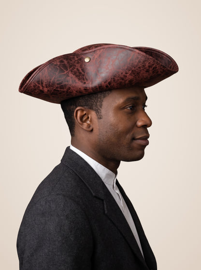 Brass Riveted Tricorn Pirate Hat in Brown, worn by a model, side profile