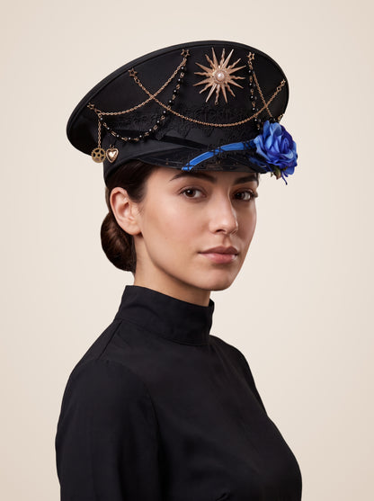 Copper Sunburst Medallion Officer Cap in Blue Roses, worn by a model, three quarter view